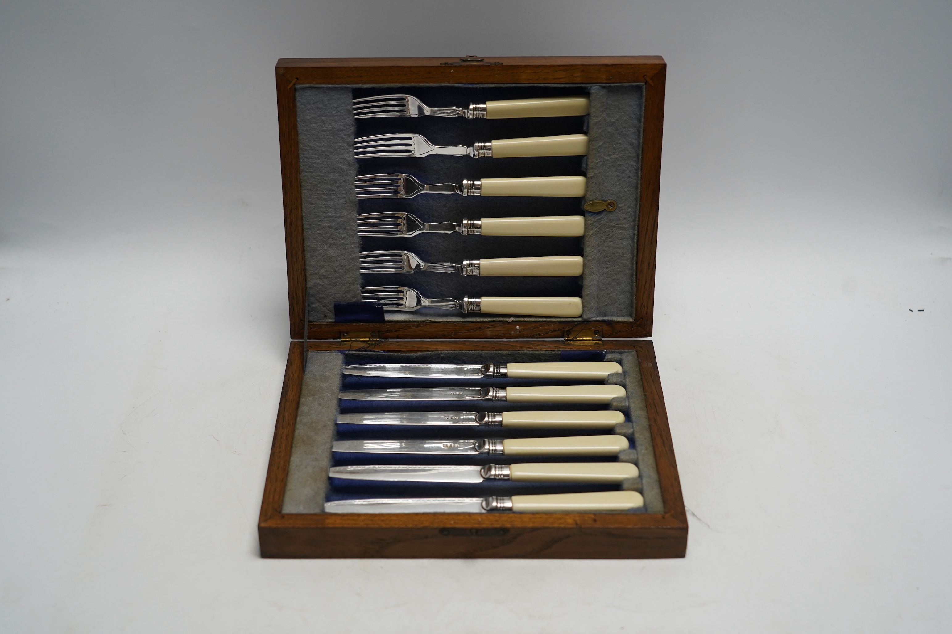Two cased sets of silver plated dessert eaters, one with mother of pearl handles, largest 30cm wide, 27cm deep. Condition - cutlery good, largest case scratched